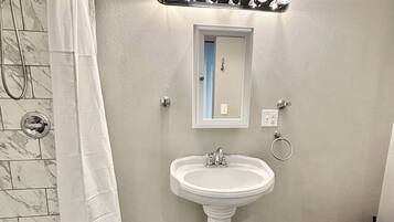 Shower, hair dryer, towels, toilet paper