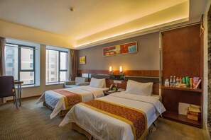 A hotel room with two beds, a desk, a chair, a bookshelf, and a painting on the wall. - Yinwan Hotel (Yingshan)