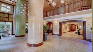 A spacious lobby with high ceilings, large columns, and a grand staircase. - Coconut Grove Retreat, bayviews, 1 park incl, wkspace, Smart TV, Pool/hottub" (Coconut Grove)
