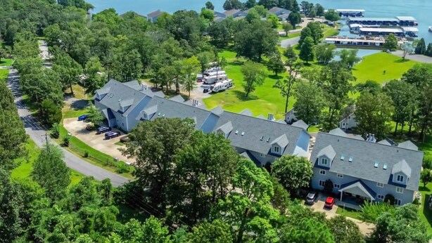 An aerial view of a lakeside property with multiple houses, a marina, and a boat dock. - Relaxing Executive Condo at Big Bear Resort - Kentucky Lake views (Benton)