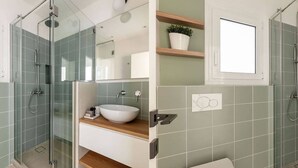 A modern bathroom with a glass-enclosed shower, a white sink, and a toilet. - Dreamy 1BR Apartment in Kolonaki (Athens)