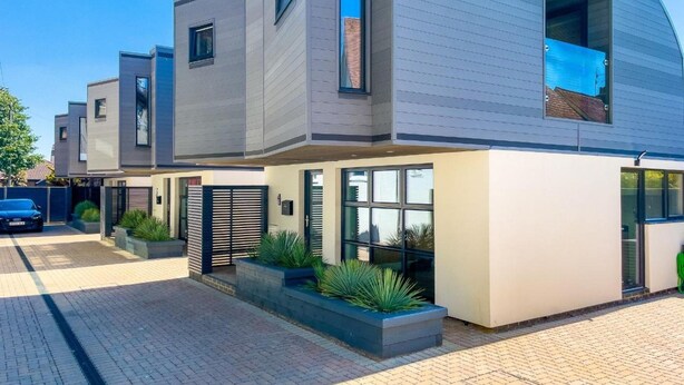 A modern two-story residential building with a flat roof, large windows, and a paved driveway. - Green Mews 3 By My Getaways (Hove)