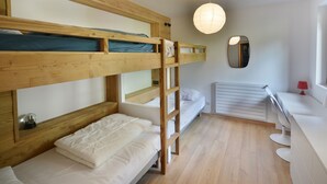 A bunk bed room with a wooden ladder, a white desk, a mirror, and a hanging light fixture. - Stunning renovated T5, bright, sleeps 10 in Morzine (Morzine)