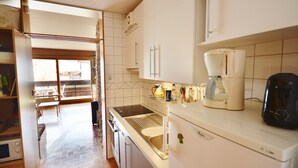 A kitchen with a built-in oven, a coffee maker, and a refrigerator. - Studio in Morzine center, 4 pers, balcony, WIFI (Morzine)