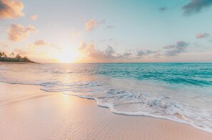 A beach with gentle waves and a sunset. - Get 1 FREE night now until November 15, 2024, book 7 nights or more! Waterfront (Providenciales)