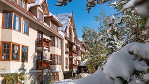 A multi-story hotel with traditional architecture, featuring balconies and large windows. - Accessible room, Central Banff, Hot Pool! (Banff)