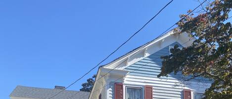 A two-story house with a porch, a front door, and a number '524' on the side.
