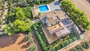 An aerial view of a property with a swimming pool, a patio area, and a large deck. - Can Cerda by Interhome (Alcúdia)
