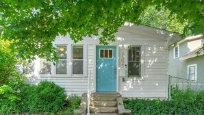 A white house with a blue door, numbered 3354, and a small front porch with steps.