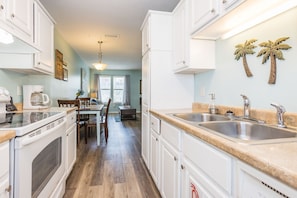 Enjoy cooking in this well-equipped kitchen with a double sink, oven, and coffee maker.