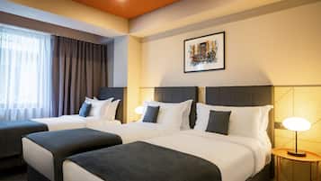 Standard Triple Room | Minibar, in-room safe, desk, laptop workspace