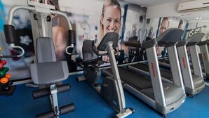 A gym with exercise equipment, including a treadmill and weight machines.
