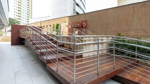 A staircase with metal railings leading to an upper level.