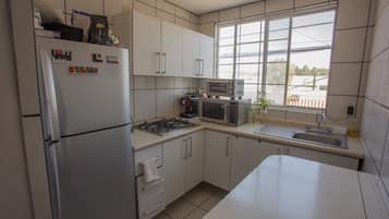 Full-sized fridge, microwave, blender, cookware/dishes/utensils