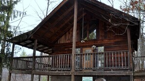 A rustic wooden cabin with a balcony, a sign for Poplar Ridge Rentals, and a plaque reading "Mountain Charm". - Romantic Secluded Cabin in Gatlinburg with Great Mountain View (Gatlinburg)