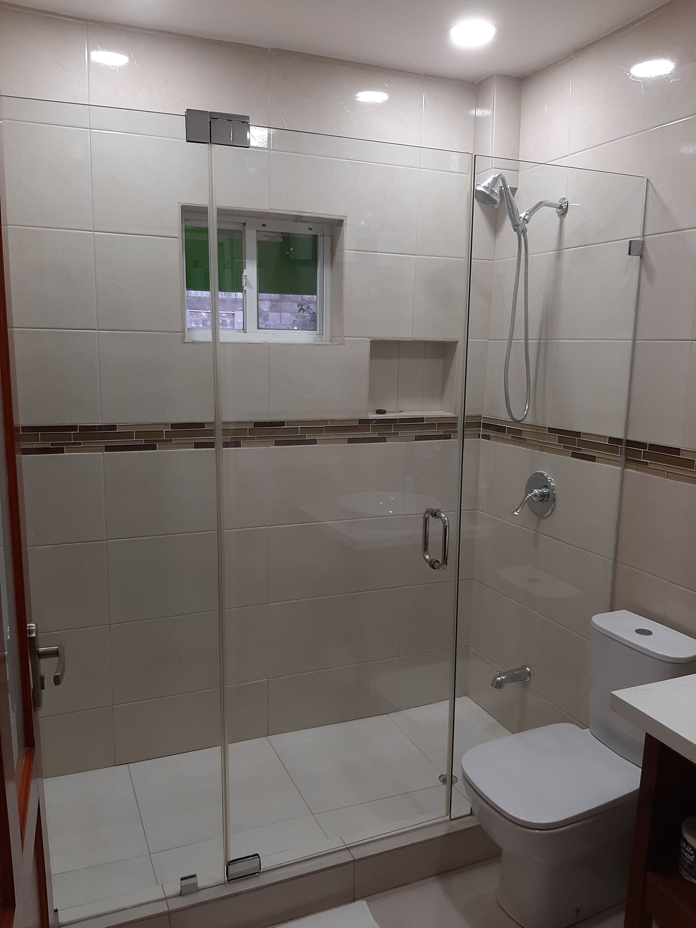 Ein modernes Badezimmer mit einer Duschkabine, einer Toilette und einem Waschbecken.