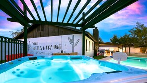 A hot tub under a pergola with a mural on the wall. - Lake Front Paradise, Pool and Hot Tub-Bubbly (Mesa)