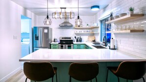 A modern kitchen with a central island, stainless steel appliances, and pendant lighting. - Lake Front Paradise, Pool and Hot Tub-Bubbly (Mesa)