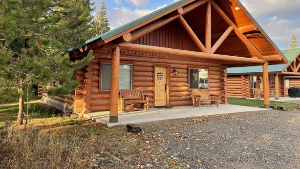 A log cabin with a porch, a bench, and a door marked with a '#' symbol.