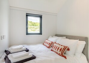 A bedroom with a bed, pillows, a window, and a view of greenery. - 2 bedroom accommodation in Halling (Halling)