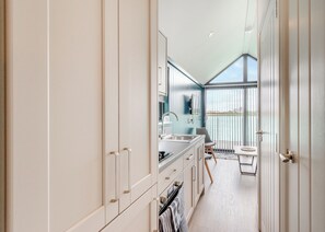 A modern kitchen with a large window, a dining area with a view, and a balcony. - 1 bedroom accommodation in Halling (Halling)