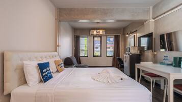 Superior Studio, 1 King Bed, City View | Living area | 14-inch TV with cable channels