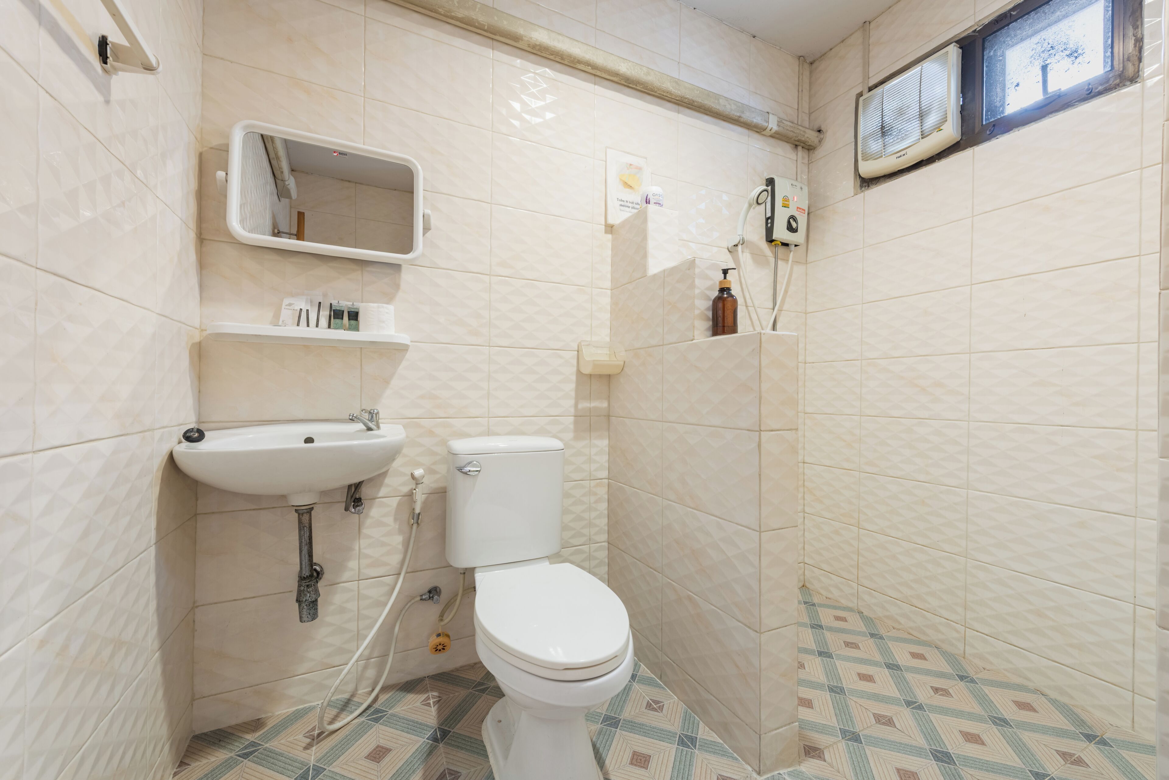 A bathroom with a toilet, sink, and shower.