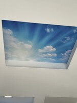 A skylight with a painted sky view.