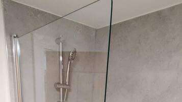 Combined shower/bathtub, deep-soaking bathtub, hair dryer, towels