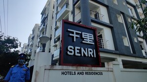 A multi-story building with a sign reading "SENRI Hotels and Residences." - Senri By Yuhi (Tada)