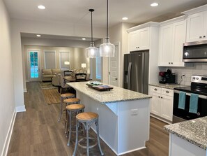 Enjoy cooking in this well-lit kitchen with a central island and oven.