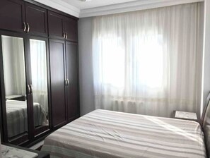 Relax in a serene space with a comfortable bed and ample storage in this stylish room.