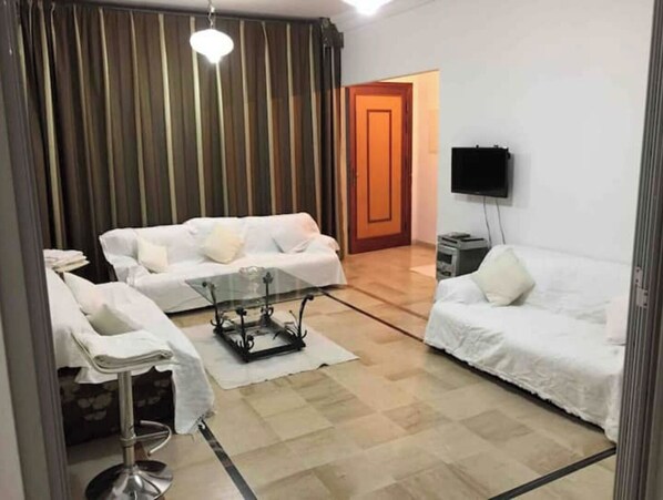 Relax in this stylish living area with a sofa, coffee table, and flat-screen TV.