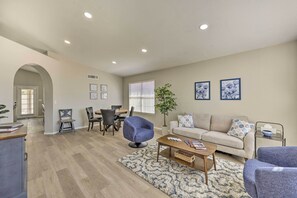 A spacious living room with a dining area, a sofa, and a coffee table.