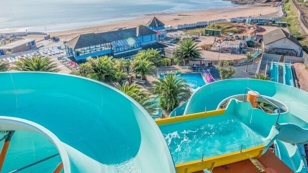 A water park with a large pool, slides, and a beach view. - Hot Tub Heaven in Beautiful Village, Close to Beaches - Blue Flag & Dog Friendly (Stoke Gabriel)