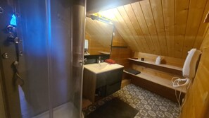 A wooden cabin bathroom with a sink, mirror, and shelves. - CHALET 12-14 Persons 200 Metres from the slopes (Fontcouverte-la-Toussuire)