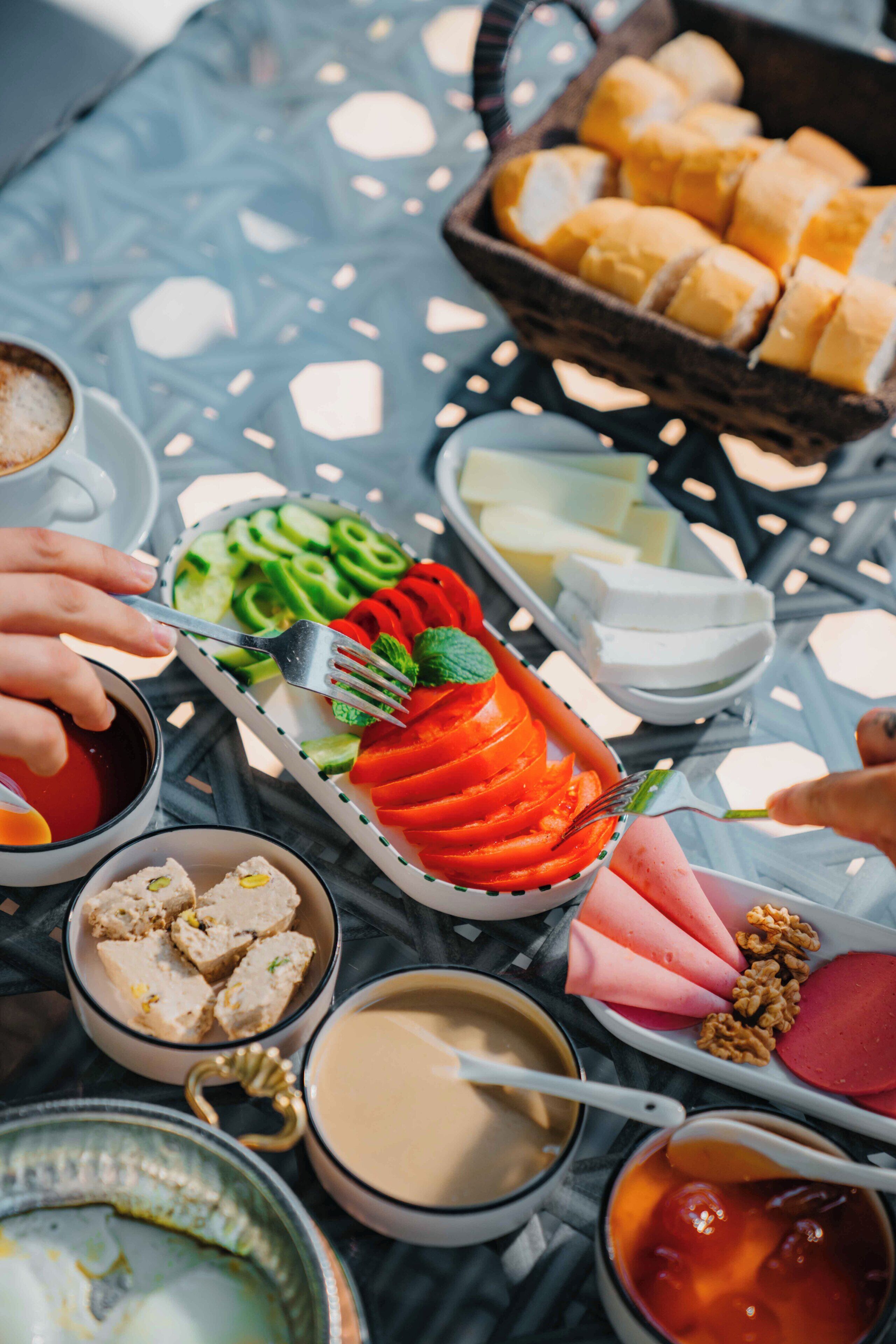 A dining table with various food items and utensils.