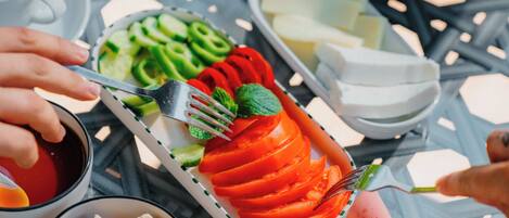 A dining table with various food items and utensils.