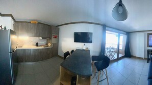 A compact living space with a kitchen, dining area, and seating area.