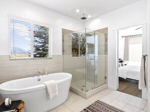 Enjoy a refreshing soak in the bathtub or invigorate with a shower, both with a view of the outdoors.