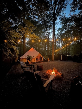 Property grounds. A luxurious glamping tent nestled in the trees.