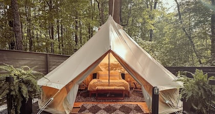 A luxurious glamping tent nestled in the trees.