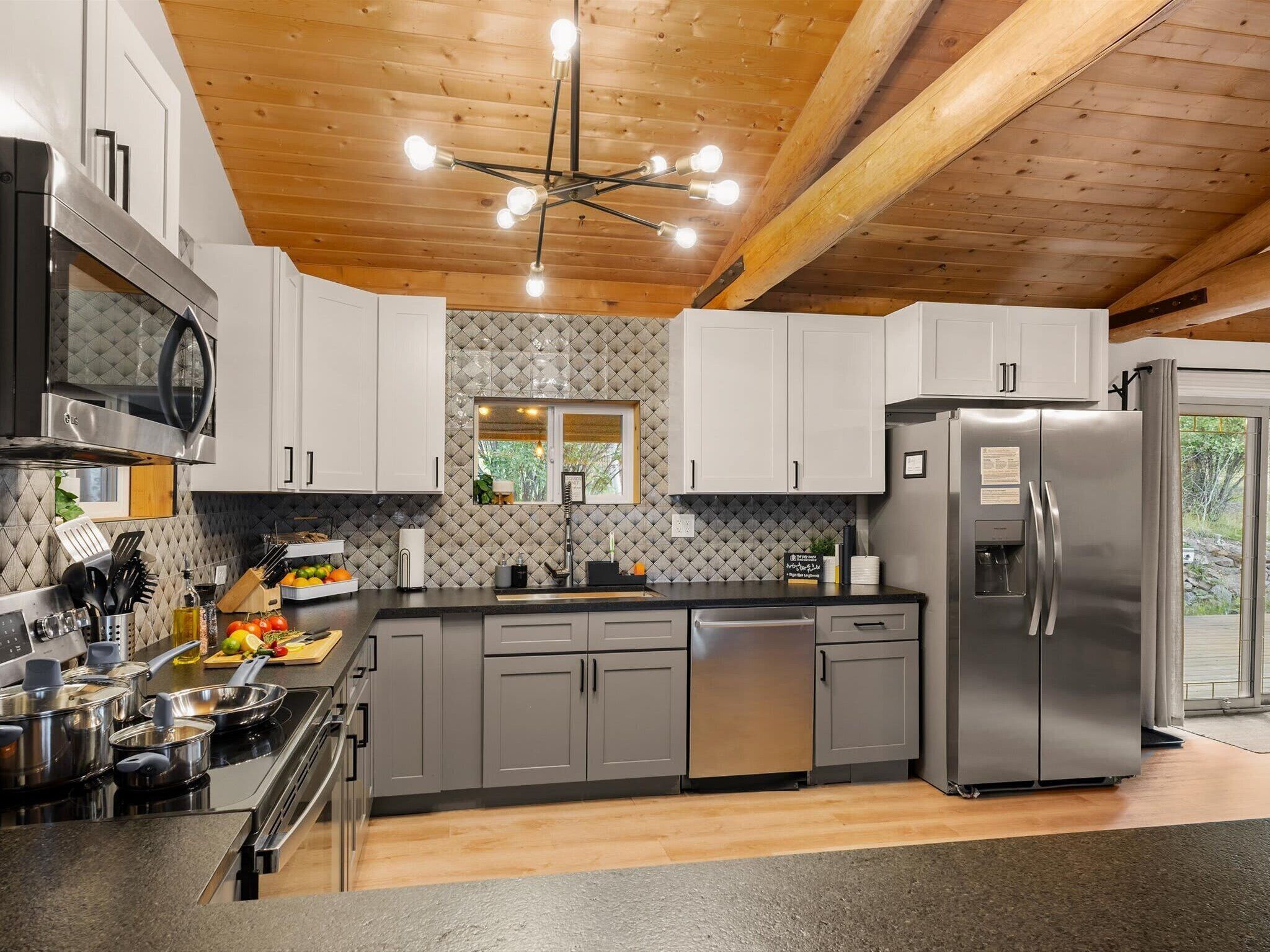 The kitchen from the other side. Near the patio doors and flowing effortlessly to the dining table, natural light, and enough room to actually enjoy cooking together.