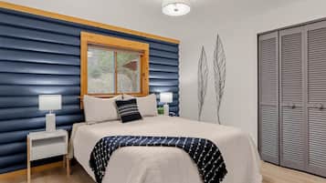 The queen third bedroom. Same blue logs, same tree views, a little cozier. Someone in your group is going to love it.