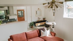 A modern living room with a sectional sofa, a small white coffee table, and a patterned rug. - Beautiful cottage w/pool in bamboo forest! (Central Point)