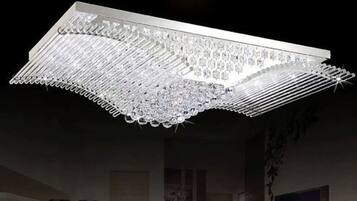 A modern chandelier with a geometric design and multiple light sources.