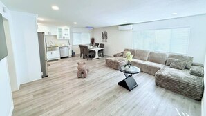 A modern apartment with a kitchen, dining area, and living room.
