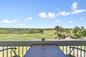 A balcony with a view of a golf course. - Amazing Golf View Condo Best view in Reunion! (Kissimmee)