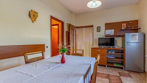 A room with a bed, a desk, a television, and a refrigerator. - 2 bedroom awesome home in Banjole (Banjole)