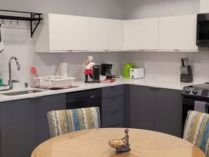 Enjoy cooking and dining in this well-equipped kitchen with a stainless steel sink, modern faucet, and dishwasher.